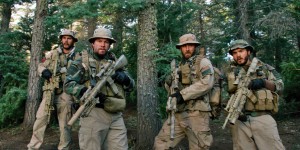 This photo released by Universal Pictures shows, from left, Taylor Kitsch, as Michael Murphy, Mark Wahlberg as Marcus Luttrell, Ben Foster as Matt Axe Axelson, and Emile Hirsch as Danny Dietz in a scene from the film, Lone Survivor." In the age of the superhero, the movies' most reliable real-life hero has been the Navy SEAL. "Lone Survivor," is the latest in a string of films, including "Zero Dark Thirty" and "Act of Valor" to honor the Navy's special operations force with as much faithfulness as the filmmakers could muster. (AP Photo/Universal Pictures)